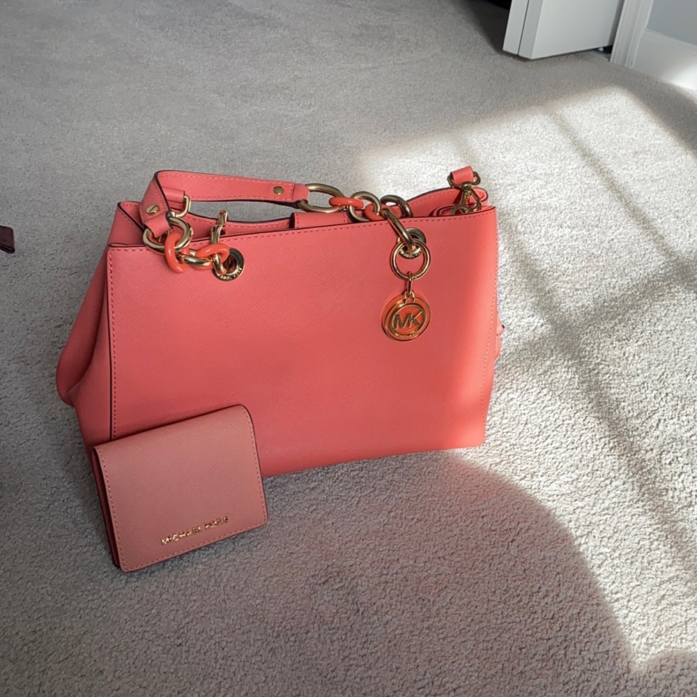Gently used Michael Kors Coral hand bag with gold hardware.